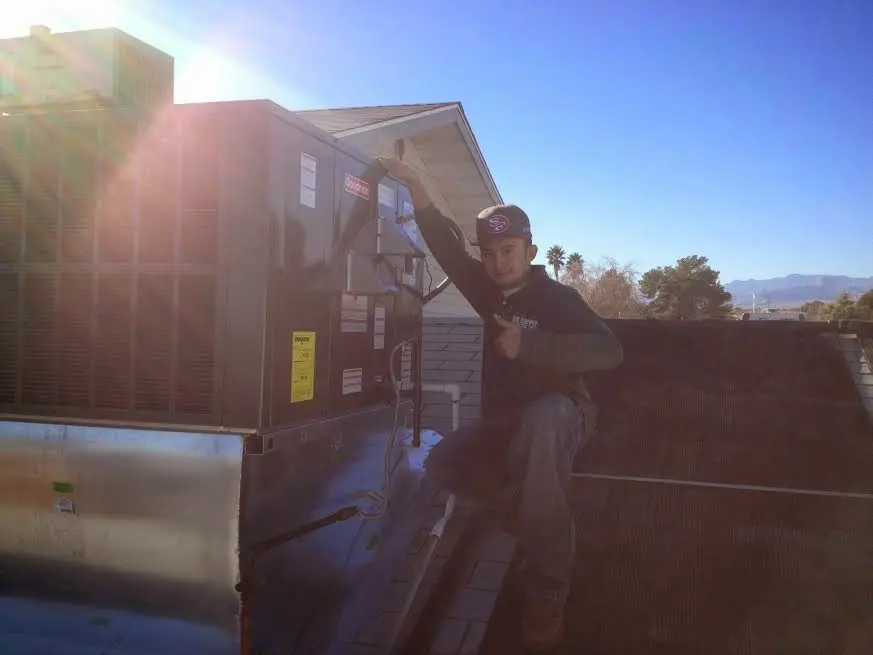 HVAC technician performing HVAC Inspection on a rooftop unit in Butler